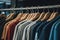 a row of shirts hanging on a rail in a store or clothing store with a variety of colors and styles of shirts on hangers