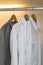 Row of shirts hanging in white wardrobe