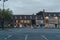 Row of shops in Stow-on-the-Wold, Cotswolds, UK,  seen over nearly empty carpark, in the evening