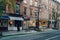 Row of shops on a street in West Village in Manhattan, New York, USA, man walking past