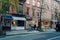 Row of shops on a street in West Village in Manhattan, New York, USA, women walking past