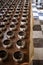 Row of silvery alms bowls with little coins inside in buddhist temple