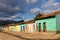 Row of small coloured houses seen in the late afternoon against a grey cloudy sky