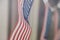 Row of small identical American flags, decorative for themes of summer, pride, Americana, USA flag concept.