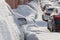 row of snow drifted cars in a row along the street near residential building at winter day snowfall