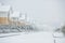 Row of the snowbound houses, homes with the sidewalk on empty st