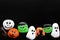 Row of Spooky Cartoon Halloween Painted Rocks Lined up Along Bot