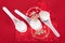 A row of spoons with dumplings on the red envelope. The Chinese characters in the picture mean `happiness`