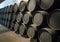 Row of stacked wooden wine barrels for sherry aging