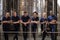 A row of staff at a wine factory smiling to camera, close up