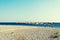 Row of straw umbrellas on the empty beach, bright blue water and sky, paradise tropical beach, relaxing time.