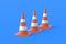 Row of striped traffic cones, barriers on blue background