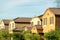 Row of suburban houses in middle class modern suburban neighborhood with double gable style rooftops