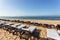 Row of sun beds for sunbathing close-up on beach in the Algarve.