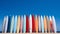 A row of surfboards sitting on top of a sandy beach