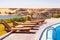 Row of swimming pool lounge chairs with the view of Nasser Lake at Abu Simbel Village