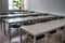 A row of tables and chairs in a classroom