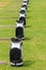 Row of Taylormade Golf Bags outdoor in rainy weather at Saadiyat Golf course Abu Dhabi