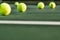 Row of Tennis Balls on Court Surface