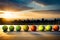 A row of tennis balls neatly lined up along the edge of a hard court, ready for a practice session