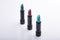 Row of three lipsticks in bold colors