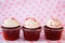 Row of three red velvet cupcakes