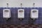 Row of three Urinals low light