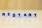 A row of tiles forming the word restart.