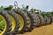 Row of tires of green tractors