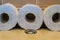 Row of toilet paper rolls laying on the water closet, bathroom products, sanitary background