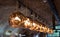 Row of Tom Dixon metallic pendant lights hanging in the Tom Dixon flagship store and showroom at Coal Drops Yard, Kings Cross.