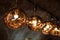 Row of Tom Dixon metallic pendant lights hanging in the Tom Dixon flagship store and showroom at Coal Drops Yard, Kings Cross.