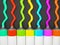 Row of tubes with multicolored paint on grey background