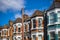 A row of typical British terraced houses in London with a telephone pole