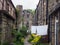 a row of typical traditional yorkshire stone houses in a small terraced street with garden flowers and washing drying on a line in