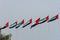 A row of United Arab Emirates UAE flags lined up and blowing in the wind