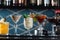 Row of various colourfull alcoholic cocktails on a bar desk. Glasses of differen shapes