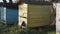 Row of vintage multicolored wooden handmade beehives on green grass