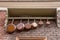 Row of vintage saucepans hanging on a shelf