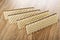 Row of wafers with porous chocolate on wooden table