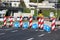 Row of warning and directional road signs marking start of road reconstruction and redirecting traffic away from construction site