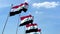 Row of waving flags of Iraq agaist blue sky, seamless loop