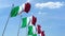 Row of waving flags of Italy agaist blue sky