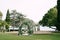 Row of wedding arches surrounded by chairs on a green lawn near the sea