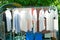 Row of wet clothes hanging on the steel rack for drying by using heat of sunlight in the traditional way.