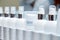 Row of white blank bottles with  cosmetic products. Moisturizing creams and other means for skincare