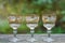 A row of white brown three glass crystal goblets