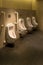 Row of white ceramic urinal chamber pot interior design men and children public toilet