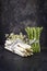 Row white and green Asparagus with flower on an old rustic metal sheet