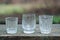 A row of white one three glass crystal goblets